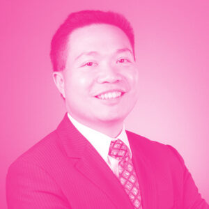 Eric Tan smiles while wearing a suit and tie. Headshot uses a hot pink filter.
