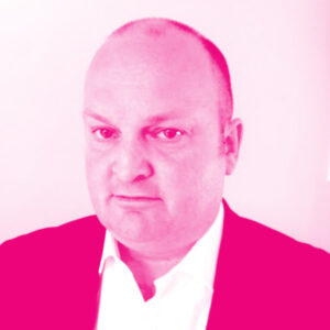 Karl Massey's headshot with a hot pink filter.