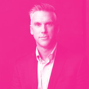 Kirk Petroski's headshot with a hot pink filter.
