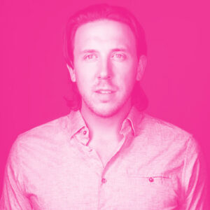 Kory Mathewson's headshot with a hot pink filter.