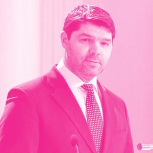 Kristjan Vassil's headshot with a hot pink filter.