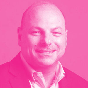 Nick Costides' headshot with a hot pink filter.