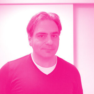 Raffi Tchakmakjian's headshot with a hot pink filter.