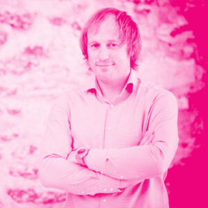 Taavi Kotka's headshot with a hot pink filter.