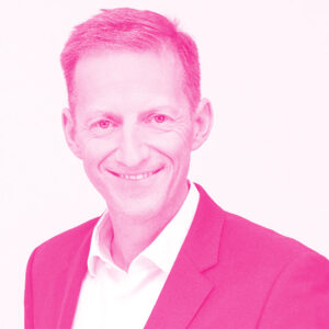 Thomas Kraft's headshot with a hot pink filter.