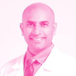 Vipan Nikore's headshot with a hot pink filter.