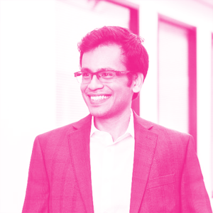 Bharat Srinivasa's headshot with a hot pink filter.