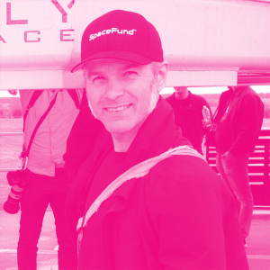 Luke Moloney's headshot with a hot pink filter.